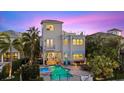 Aerial view of waterfront home with a pool, dock, and lush tropical landscaping at 4607 5Th Ne Ave, Bradenton, FL 34208