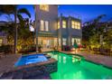 Inviting backyard pool and spa with a brick patio and lush tropical landscaping at 4607 5Th Ne Ave, Bradenton, FL 34208