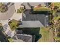 Aerial view of home with screened-in lanai, fenced yard, and patio seating at 4611 Los Robles Ct, Palmetto, FL 34221