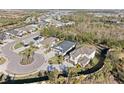 Aerial view of a home in a residential neighborhood featuring mature trees and sidewalks at 4611 Los Robles Ct, Palmetto, FL 34221