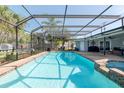 Relaxing screened-in pool area with a spa, perfect for outdoor entertaining and enjoying sunny days at 4807 W Country Club Dr, Sarasota, FL 34243