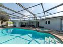 Relaxing screened-in pool area with a spa, perfect for outdoor entertaining and enjoying sunny days at 4807 W Country Club Dr, Sarasota, FL 34243