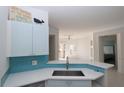 Bright kitchen featuring blue cabinets, stainless sink and appliances, and open layout at 5168 Northridge Rd # 209, Sarasota, FL 34238