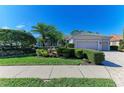 Well-maintained home exterior featuring a three-car garage and meticulously landscaped front yard at 5224 88Th E St, Bradenton, FL 34211