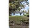 Quaint single-story home with a well-kept lawn and mature trees offering ample shade at 6510 E 26Th Ave, Tampa, FL 33619