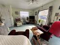 Cozy living room bathed in sunlight with comfortable seating and a ceiling fan at 6510 E 26Th Ave, Tampa, FL 33619