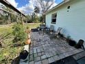 Relaxing brick patio featuring outdoor seating, perfect for enjoying the backyard at 6510 E 26Th Ave, Tampa, FL 33619