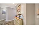 Elegant hallway with wood floors, decorative artwork, and a stylish accent table at 7910 34Th W Ave # 203, Bradenton, FL 34209