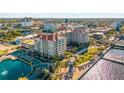 Beautiful condo building with red tile roof, gorgeous landscaping, pool, and water views at 808 3Rd W Ave # 205, Bradenton, FL 34205