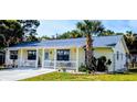 Charming single-story home featuring a welcoming front porch and beautiful landscaping at 820 Coconut Rd, Venice, FL 34293