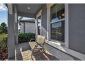 Cozy covered front porch with comfortable seating, offering a relaxing outdoor space at 8726 Backshore Ln, Parrish, FL 34219
