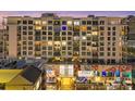 Modern condo exterior view highlights balconies, murals, and architectural details from street level at night at 111 S Pineapple Ave # 804, Sarasota, FL 34236