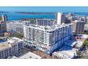Daytime exterior view showcasing a modern condo building with balconies and vibrant street-level murals at 111 S Pineapple Ave # 804, Sarasota, FL 34236