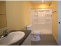 Bright bathroom with updated vanity, toilet, and shower featuring a built in shelving system at 11337 Pineapple Rd, Punta Gorda, FL 33955