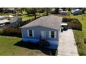 Aerial view of a single-story house with gray siding, white trim, landscaped yard, and private driveway at 11337 Pineapple Rd, Punta Gorda, FL 33955