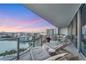 Spacious balcony with lounge chairs offering beautiful water and city views, ideal for relaxation at 1155 N Gulfstream Ave # 1205, Sarasota, FL 34236