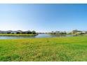 Expansive green backyard overlooking a serene community lake at 12140 Whisper Lake Dr, Bradenton, FL 34211