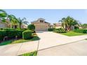 Single-story home featuring a manicured lawn, landscaping, and a two-car garage at 12140 Whisper Lake Dr, Bradenton, FL 34211