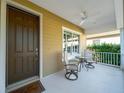 Inviting front porch with comfortable seating and a ceiling fan, perfect for relaxing at 12140 Whisper Lake Dr, Bradenton, FL 34211