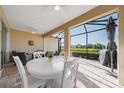 Spacious screened-in patio with a dining table and comfortable seating area, perfect for entertaining at 12140 Whisper Lake Dr, Bradenton, FL 34211