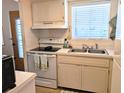Well-maintained kitchen featuring white appliances, ample counter space, and natural light at 1531 Pleasant Rd # H-3, Bradenton, FL 34207