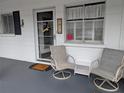 Inviting condo porch with two chairs and small table, creating a cozy outdoor living space at 1531 Pleasant Rd # H-3, Bradenton, FL 34207