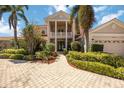 Elegant two-story home featuring manicured landscaping and a welcoming stone pathway to the front door at 17809 Howling Wolf Run, Parrish, FL 34219