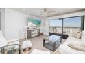 Bright and airy living room with sliding glass doors to a balcony with ocean views at 20 Whispering Sands Dr # 301, Sarasota, FL 34242