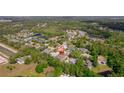 An aerial view of the home nestled within a community surrounded by lush greenery and lakes at 2114 147Th E Ct, Bradenton, FL 34212