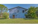 Charming two-story home with a wooden door and a serene, natural setting at 2230 Myakka Rd, Sarasota, FL 34240