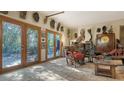 Eclectic living room showcasing decor with a variety of unique statues and wooden furniture at 2230 Myakka Rd, Sarasota, FL 34240