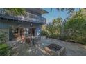 Spacious outdoor patio with seating area, grill, and a unique brick fire pit feature at 2230 Myakka Rd, Sarasota, FL 34240