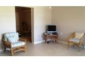 Cozy living room featuring tile floors and comfortable wicker furniture, perfect for relaxation at 22337 Olean Blvd, Port Charlotte, FL 33952