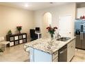 Bright kitchen featuring stainless steel appliances, granite countertops, and a functional island at 2846 Midnight Pearl Dr, Sarasota, FL 34240