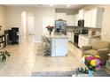 Open-concept kitchen flows into living area, featuring stainless appliances and a large center island at 2846 Midnight Pearl Dr, Sarasota, FL 34240