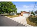 Spacious home featuring a long driveway, beautiful landscaping, and an attached two-car garage at 3502 18Th Avenue W Dr, Bradenton, FL 34205