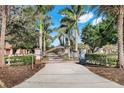 Elegant gated entrance flanked by palm trees and manicured landscaping, offering privacy and curb appeal at 3551 Ridgeland Ct, Punta Gorda, FL 33982