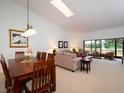 Cozy living room area next to the dining table and a window showcasing outdoor scenery at 3922 Wilshire Cir # 177, Sarasota, FL 34238