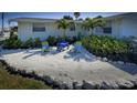 Relaxing home featuring outdoor seating surrounded by beautifully landscaped grounds at 401 63Rd St, Holmes Beach, FL 34217