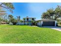 Charming two-story home with well-maintained lawn, blue door, and attached garage at 4283 Southwell Way, Sarasota, FL 34241