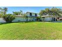 Charming two-story home with well-maintained lawn, blue door, and attached garage at 4283 Southwell Way, Sarasota, FL 34241