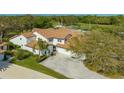 Aerial view of a pristine home with manicured lawns, an inviting driveway, and a classic red tile roof at 4404 Calle Serena, Sarasota, FL 34238