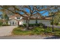 Charming home exterior featuring a tile roof, lush landscaping, and a classic mailbox at the curb at 4404 Calle Serena, Sarasota, FL 34238