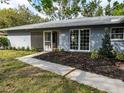 Up-close front exterior view with a screened entrance way with a large front window at 4453 Meadow Creek Cir, Sarasota, FL 34233