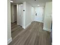 Well-lit hallway with neutral-toned walls and wood-look flooring, with multiple doors, including a closet at 4460 Fairways Blvd # 304, Bradenton, FL 34209