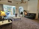 Inviting living area with comfortable sofas, sliding glass doors to pool, and easy access to other rooms at 4464 Mcintosh Lake Ave, Sarasota, FL 34233