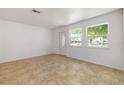 Bright and airy living room with neutral tile flooring, complemented by natural light from windows at 510 Marlin Dr, Punta Gorda, FL 33950