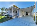 Charming single-story home featuring a cozy front porch and covered carport with added storage at 5619 Bayshore Rd # 107, Palmetto, FL 34221