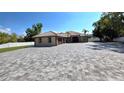 A well kept ranch home features a tile roof, attached garage, and beautiful paved driveway at 5714 38Th E Ave, Bradenton, FL 34208
