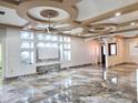 Open living room with decorative ceilings, tile flooring, and wall niches at 5714 38Th E Ave, Bradenton, FL 34208